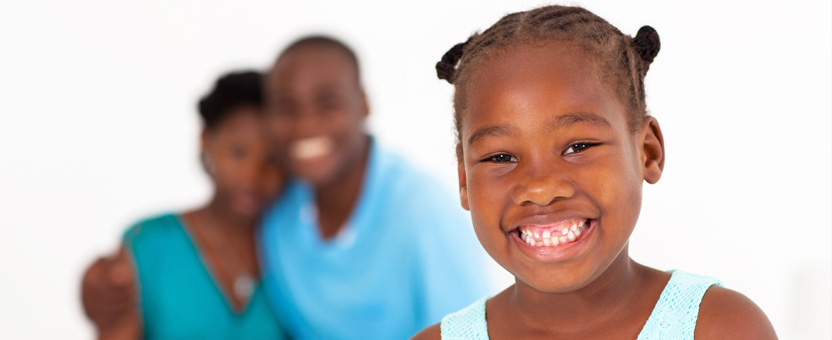 Smiling happy child with her parents