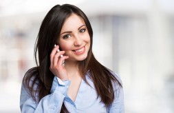 Young smiling woman talking on the mobile phone