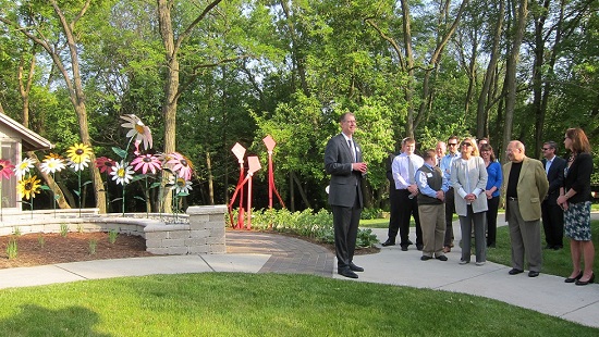 Man speaking to crowd at opening of the healing garden