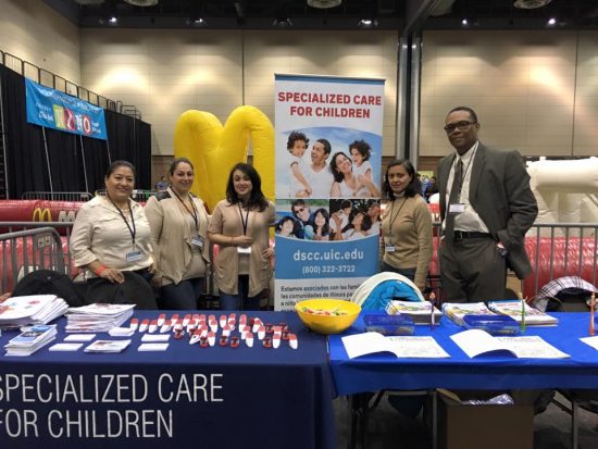 DSCC staff stand at their booth at 2016 Dia Del Nino event