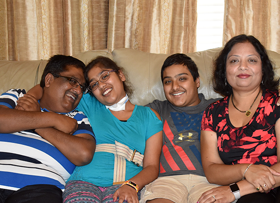 Saurabh Agarwal smiling and seated with his daughter, Radhika; son, Ayush; and wife, Mukta.