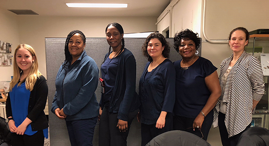 Five Chicago Public Health Department nurses and a hearing screening trainer pose together.