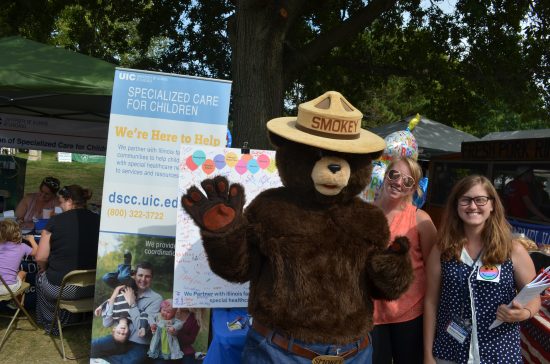 DSCC employees pose with Smokey the Bear at the 2017 Illinois State Fair