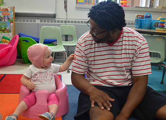 Deaf infant plays with an instructor during the 2018 Institute for Parents of Preschool Children who are Deaf or Hard of Hearing