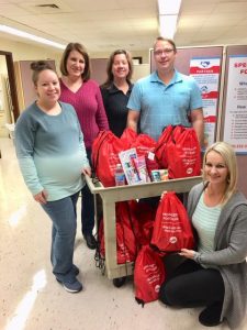 DSCC's Marion and Olney RO staff pose with backpacks filled with items for family caregivers