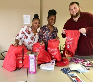 DSCC's Champaign Regional Office staff fill red backpacks with items for family caregivers.