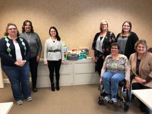 DSCC's Peoria RO staff pose with items they donated to Almost Home Kids. 