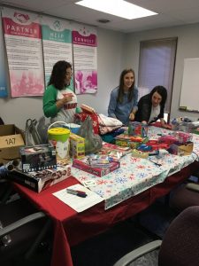DSCC Olney Regional Office staff wrap presents for a family in need