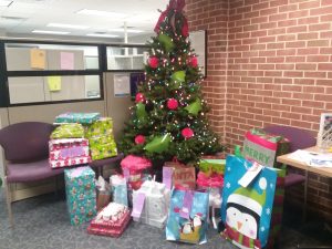 Donated gifts from the DSCC Rockford Regional Office under a Christmas tree