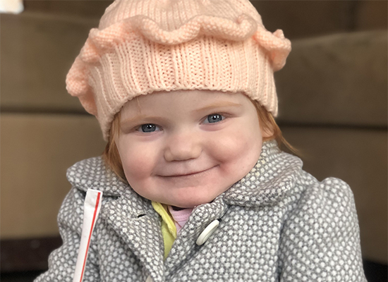 Eloise Hoffman smiles while holding a straw