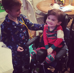 Nash's older brother, Blake, pretends to check Nash with a stethoscope.