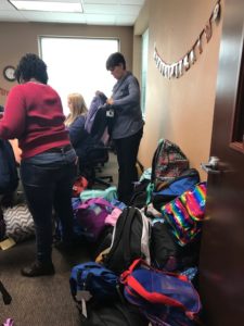 DSCC staff sort donated backpacks for our participants. 