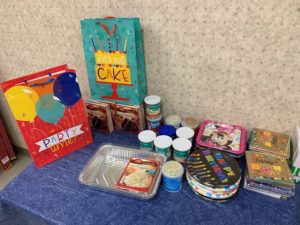 Cake mix, frosting, plates and other items that DSCC's Champaign Regional Office collected for their birthday bag project.