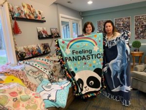 DSCC Program Coordinator Assistant Kim Firkins (right) delivers fleece blankets to Almost Home Kids Naperville. 