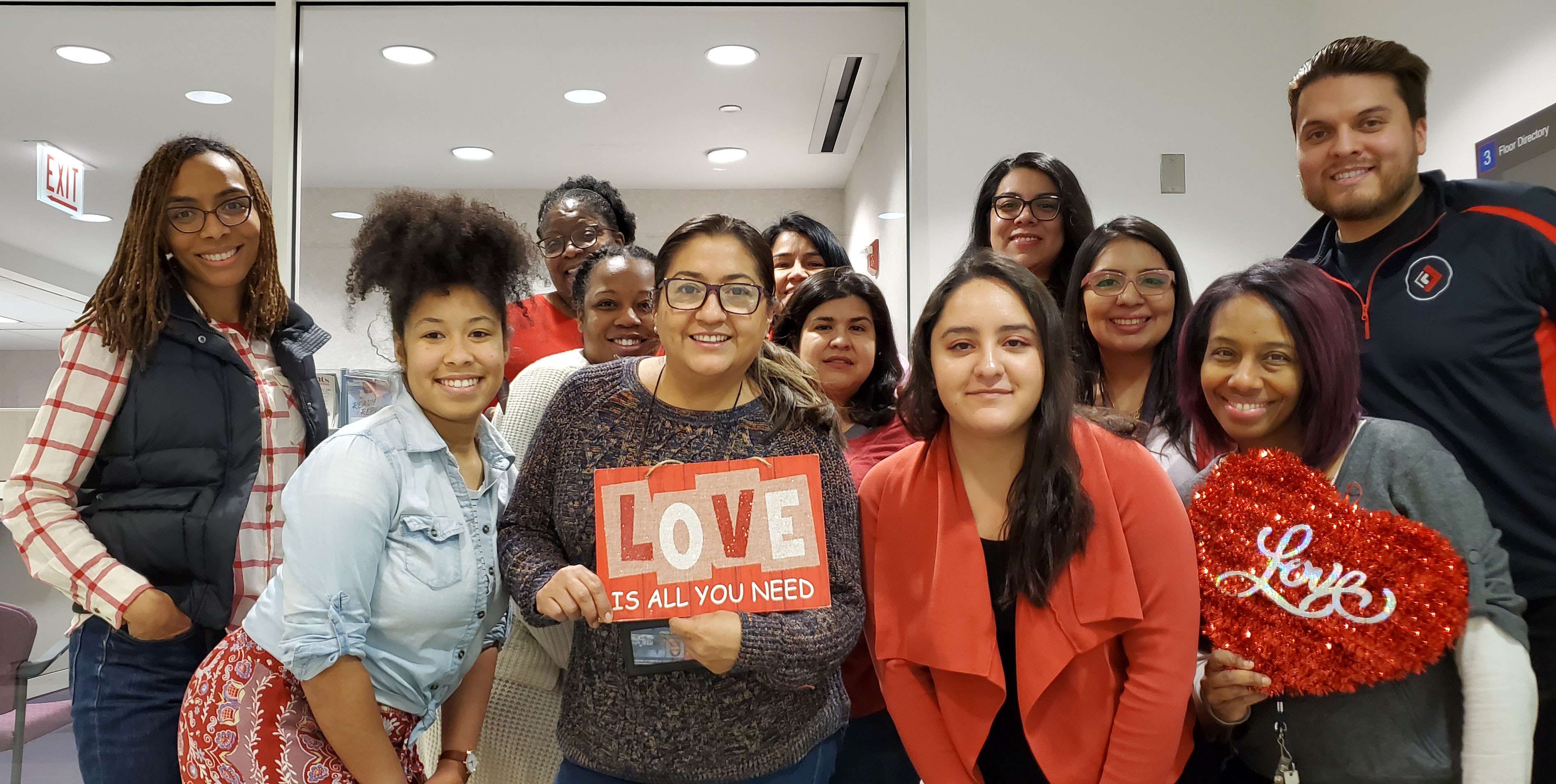 Lisette Rios and a group of her DSCC Chicago Core Regional Office co-workers pose  together while wearing red for National Wear Red Day. 