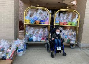 Axel poses with the 160 Easter baskets his family donated for pediatric patients at Central DuPage Hospital.