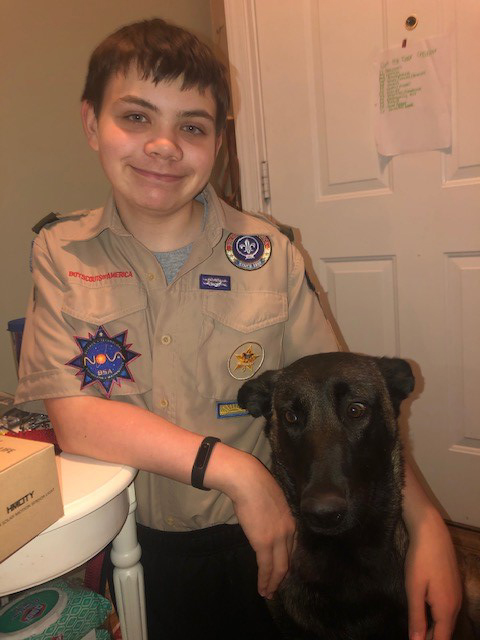 Nathan Lichucki in his Scout uniform with his service dog, Dakota