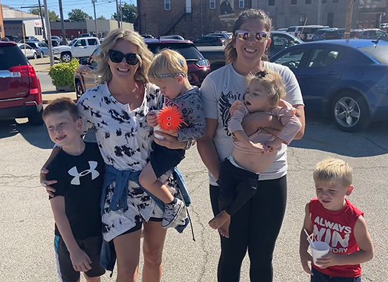 Lace Mandrell and Bailey Imig pose and smile with their children