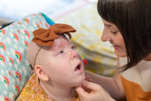 Erica Stearns smiles at her daughter, Margot, while gently holding her face