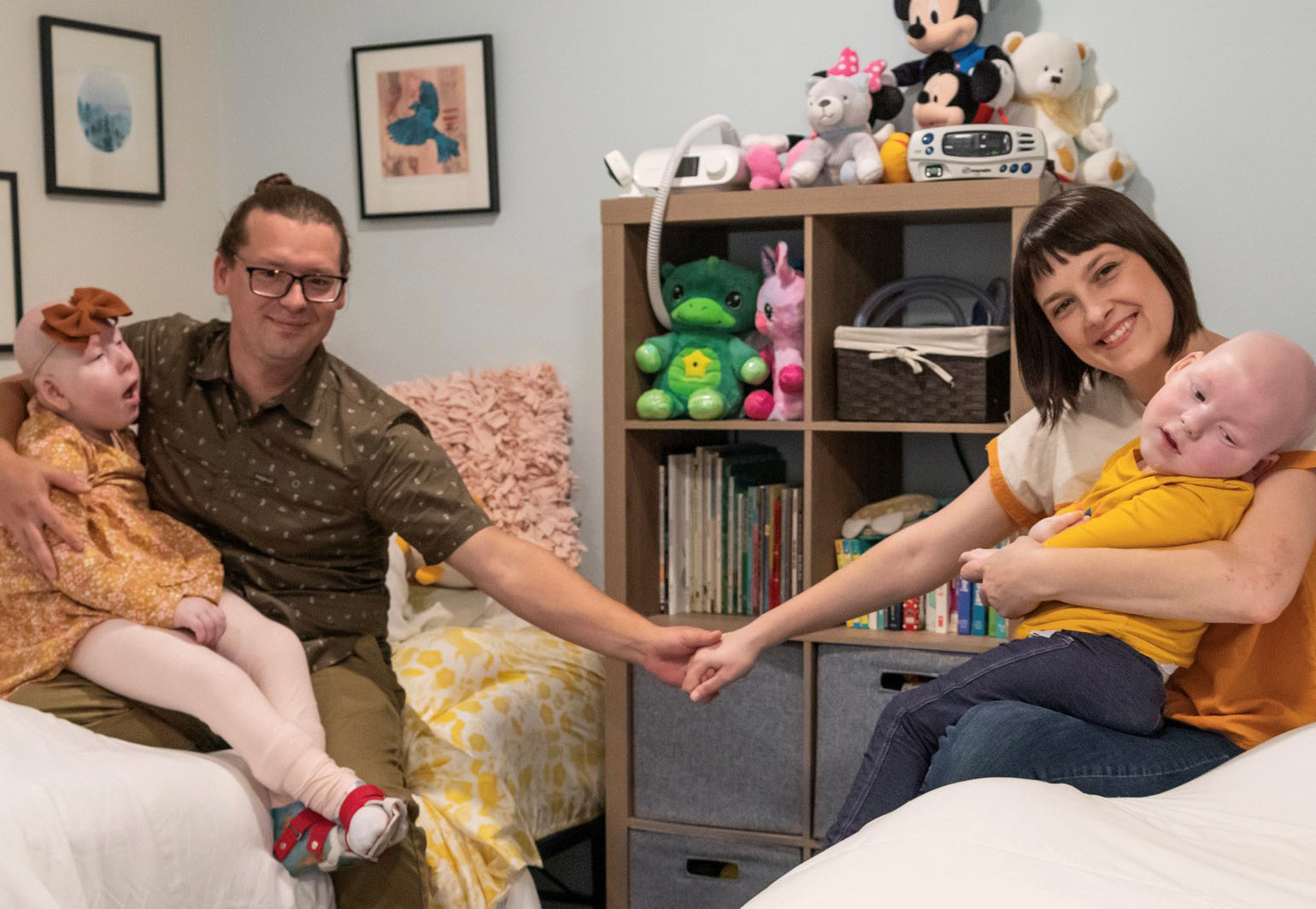 Erica Stearns and her husband hold hands while they each hold one of their two children with complex medical needs