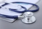 blue stethoscope and tablet on white background