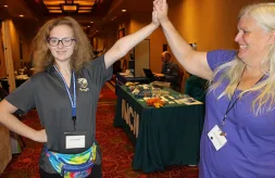 DSCC participant Vera Lindquist gives her grandmother, Cheryl, a high five during the 2023 Illinois Statewide Transition Conference