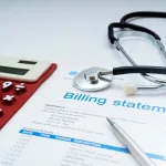 Healthcare billing statement with a calculator, stethoscope and pen