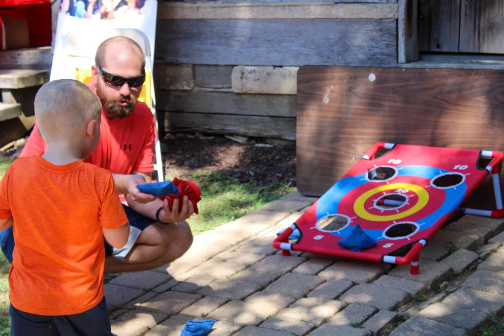 Zack Alumbaugh runs the bean bag toss at the 2023 Illinois State Fair.